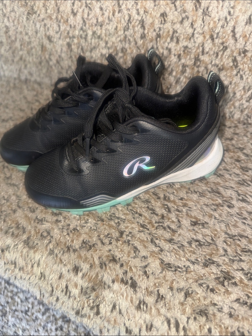 Kids Black Rawlings baseball cleats with Mint Accent